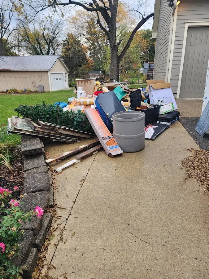 Dumpster being loaded with debris for 3 Yard Dumpster Rental in West Palm Beach